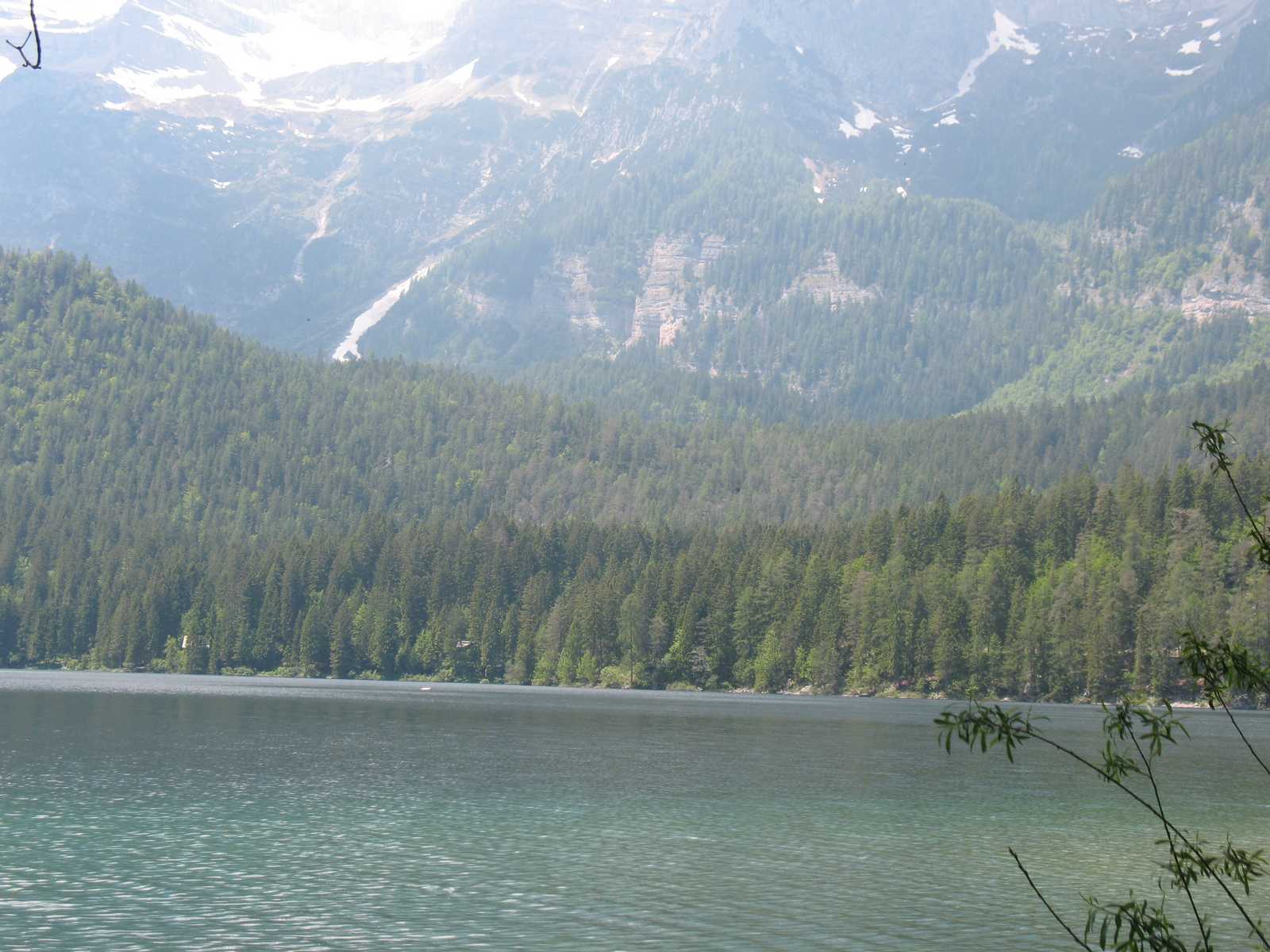 אגם מוקף הרים עם מים שקטים ונוף אלפיני אופייני לאזור לומברדיה